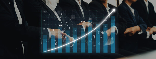 Group of business professionals in formal attire observing a digital screen displaying financial growth metrics during a corporate meeting on market trends. Axiom