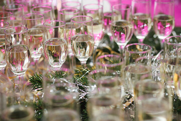 Champagne flutes with festive pink lights