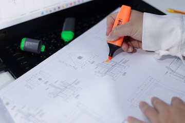 Female Engineer Checking the Blueprint of a Foundation and Pedestal