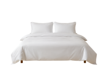 Neatly made bed with white pillows and comforter