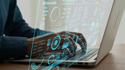 A professional workspace featuring hands typing on a laptop with an overlay of business data and analytics visualization, highlighting technology and modern insights. Cipher