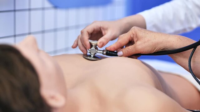 Medical student learning examination skills on a patient dummy with stethoscope