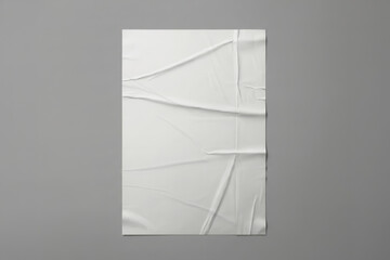 Fototapeta premium Glued wrinkled paper poster mockup on gray background