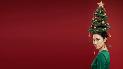 Photorealistic portrait of a asian woman in a bright green dress, evening makeup, and a high cone hairstyle styled as a Christmas tree with ornaments, garlands, glowing star on top, soft frontal ligh