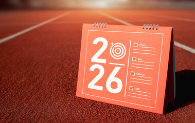 Calendar page of 2026 with target symbol and checklist Plan-do- Check-Act. Concepts of planning success, and Deming cycle for continuous improvement.