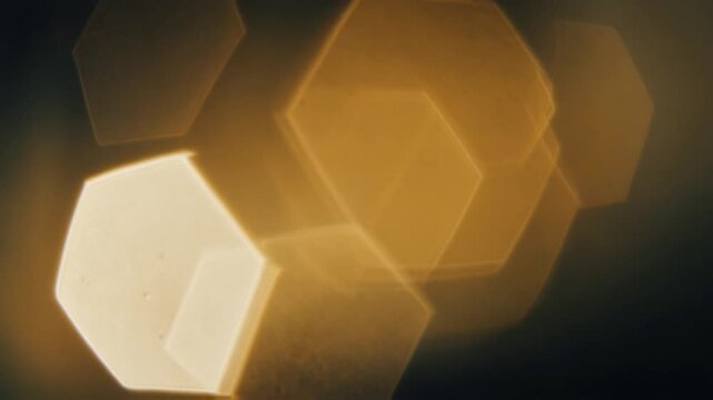 Shimmering golden hexagonal bokeh light effect overlay background