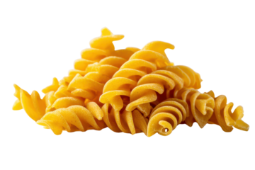 Pile of golden yellow fusilli pasta spirals against a solid black background rotini macaroni
