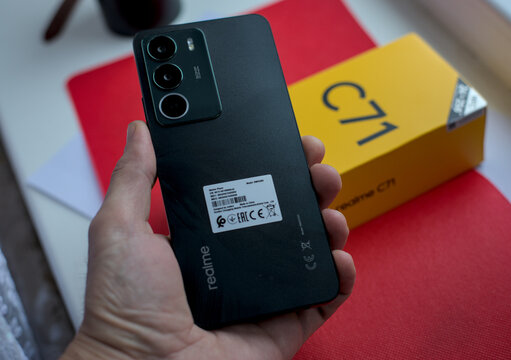 Teplyk, Ukraine, December 24, 2025: Male hand holding the new smartphone Realme C71