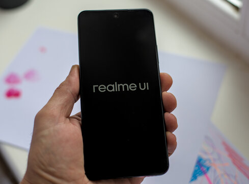 Teplyk, Ukraine, December 24, 2025: Human hand holding the new smartphone Realme C71 while turning on.