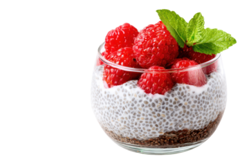 Glass of chia seed pudding with raspberries and mint garnish on black raspberry