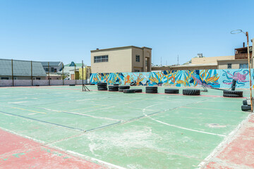 Colorful colonial buildings in Lüderitz, a small coastal town in Namibia, facing the Atlantic Ocean. Historic German architecture contrasts with desert landscapes, harbor views. © coffeinlix 