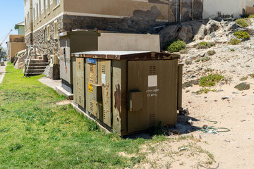 Colorful colonial buildings in Lüderitz, a small coastal town in Namibia, facing the Atlantic Ocean. Historic German architecture contrasts with desert landscapes, harbor views. © coffeinlix 