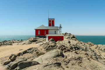 Colorful colonial buildings in Lüderitz, a small coastal town in Namibia, facing the Atlantic Ocean. Historic German architecture contrasts with desert landscapes, harbor views. © coffeinlix 