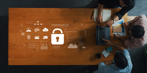 Professionals collaborate on cybersecurity strategies at a modern office setting, surrounded by data visualizations and a lock symbol representing secure information management. Trope