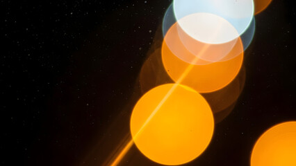 Night Bokeh Lights Photograph, Abstract Warm and Cool Bokeh, Diagonal Glowing Light Circles, Soft Focus Night Sky Lights, Atmospheric Black Background Bokeh Image