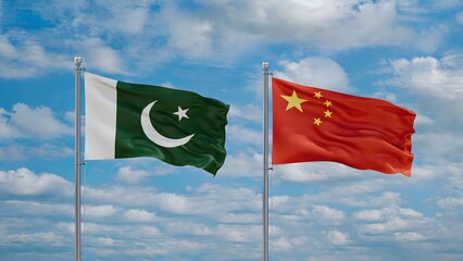 Pakistan and China flags flying together under clear blue sky