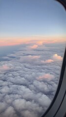 Aerial view of clouds from airplane window during peaceful flight
