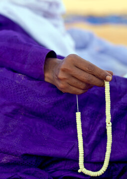 Tuareg man praying with beads, Fezzan, Umm al-Maa, Libya