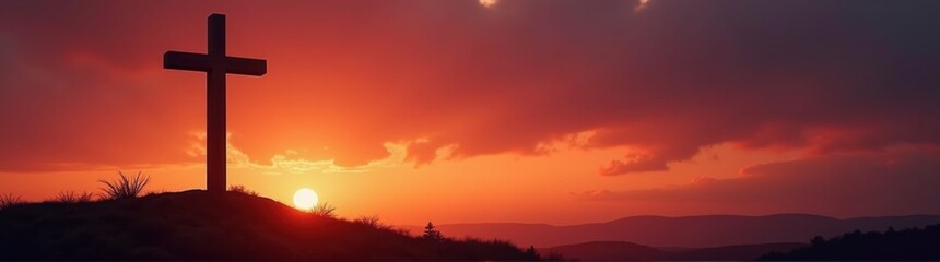 Cross on a hill with a sunset in the background