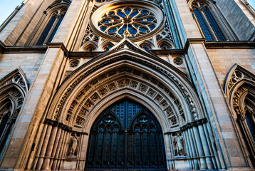 Obraz premium A majestic grand cathedral entrance with intricately carved stone facade and ornate decorations under natural light