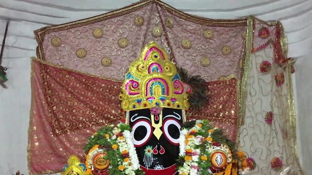 Lord Jagannath Idol with Ornate Crown and Floral Garlands, Decorated Hindu Deity in Odisha Tradition, Devotional Temple Worship, Spiritual and Cultural Heritage