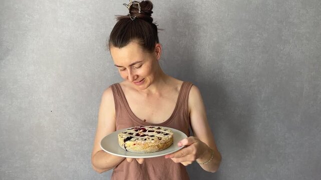 A Happy Woman Enjoying a Slice of Homemade Pie in Her Cozy Kitchen
