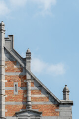 Historic Brick Building Gable Against Blue Sky