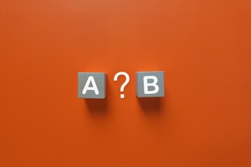Gray blocks with white letters and question mark on orange background
