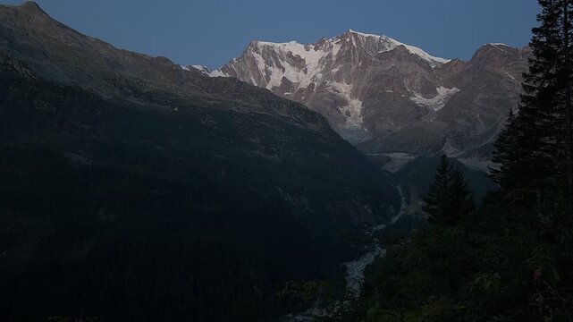 Time lapse mountain with glacier at sunrise, natural summer landscape from above. Italian Alps with Monte Rosa in Anzasca valley, Macugnaga village, Italy. Panoramic view