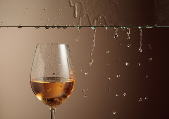 White wine flows down into a glass.