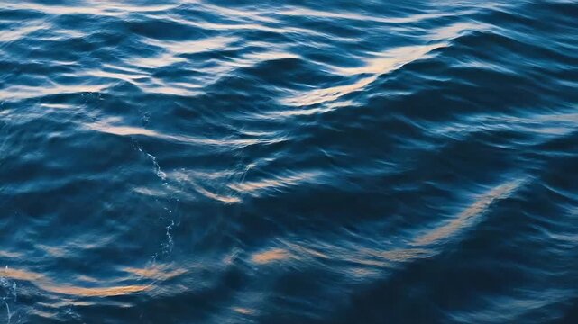 Deep Blue Ocean Waves with Soft Golden Light Reflections