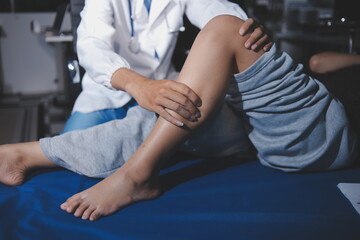 Rehabilitation therapy Professional male physiotherapists working in rehabilitation centers while treating male patients with leg and muscle pain.