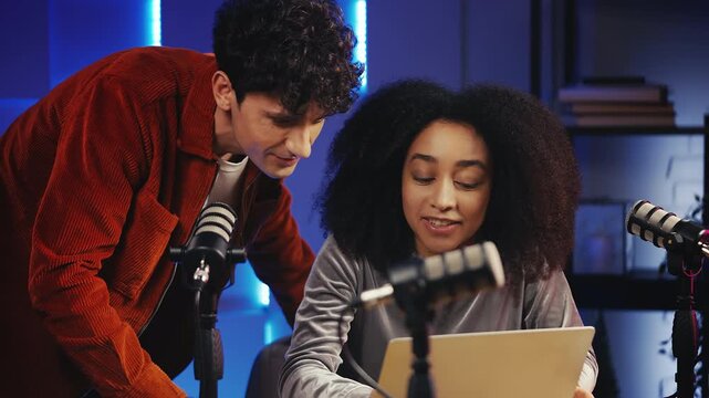 Two podcast hosts celebrating successful charity campaign, giving high-five