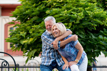Happy senior couple smiling and hugging
