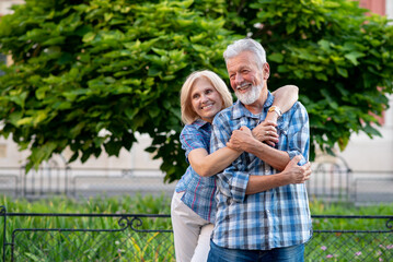 Happy senior couple smiling and hugging
