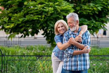 Happy senior couple smiling and hugging
