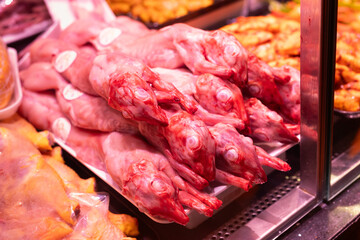 Meat department of supermarket - raw pig carcasses are on display in refrigerator