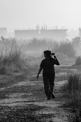 Female Wildlife Photographer Walking Through Foggy Forest with Telephoto Lens