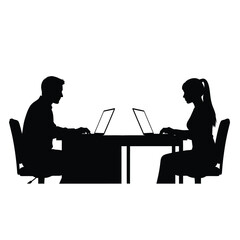 Two people working on laptops at a table focused on their screens silhouette