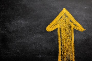 A yellow, hand-drawn arrow points upwards on a textured, black background, suggesting growth and progress. The arrow's simple design is chalk-like