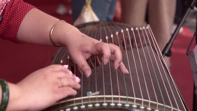 Chinese traditional musician playing Chinese guzheng