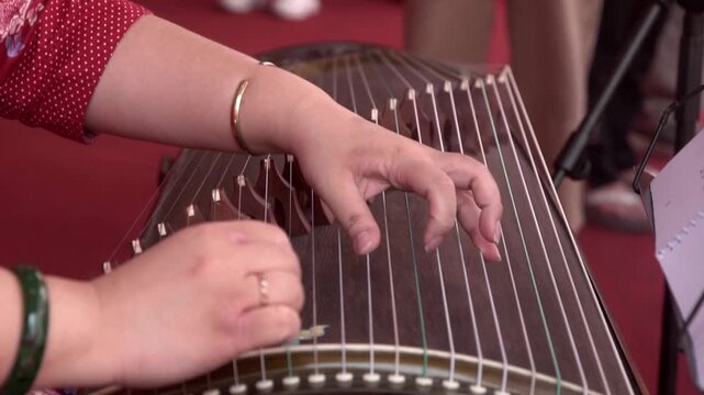 Chinese traditional musician playing Chinese guzheng