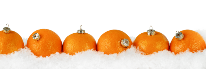 Mandarins or tangerines in form of christmas fir tree ornament in snowdrift with falling snow isolated on white background with clipping path. Banner Christmas baking. Design element.