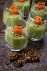 Smoked salmon shot glasses guacamole served with homemade crackers. High quality photo