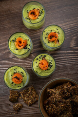 Smoked salmon shot glasses guacamole served with homemade crackers. High quality photo