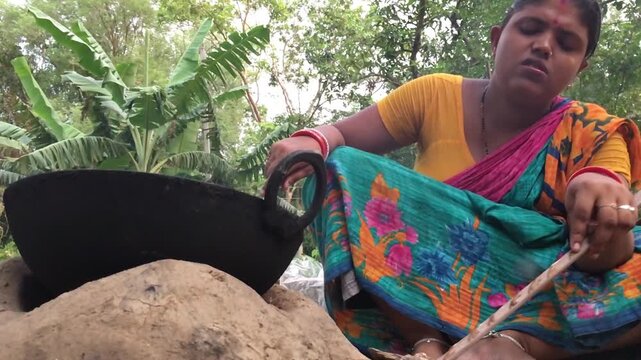 Rural Indian Woman Cooking Outdoors in Traditional Village Kitchen, Preparing Food on Wood Fire Chulha, Authentic Indian Lifestyle, Culture and Rural Life