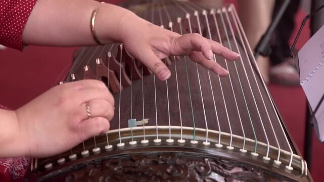 Chinese traditional musician playing Chinese guzheng