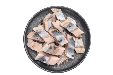 Salted herring pieces with peppercorns and parsley in black plate. isolated white background seafood appetizer with copy space.