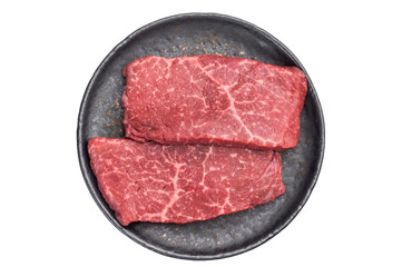 Raw premium beef steak flatiron top blade cut on dark plate top view fresh red meat ingredient for steakhouse cuisine