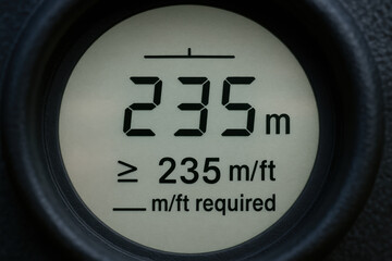 Distance measurement device showing 235 meters with safety and crane related precision for accurate height or length checking construction